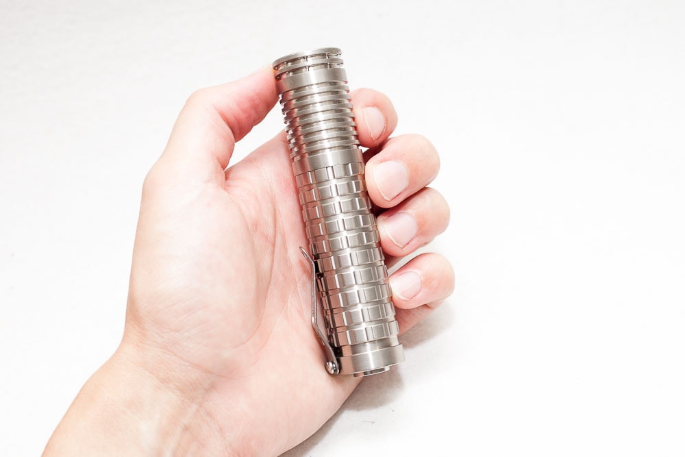 18650 style Reylight titanium flashlight in hand