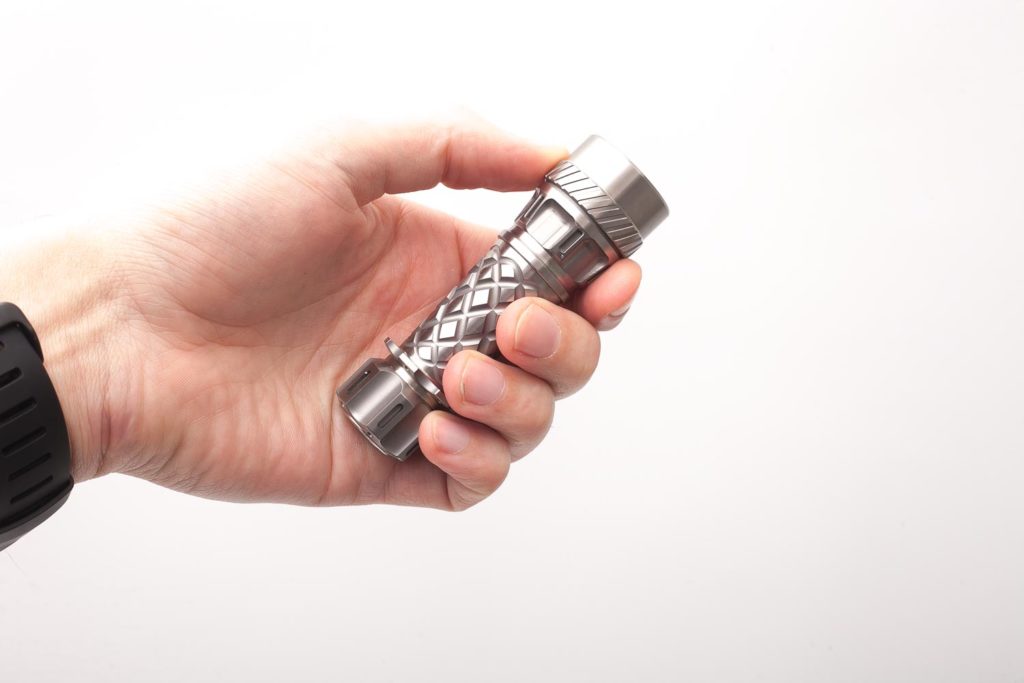 titanium jetbeam flashlight holding in hand