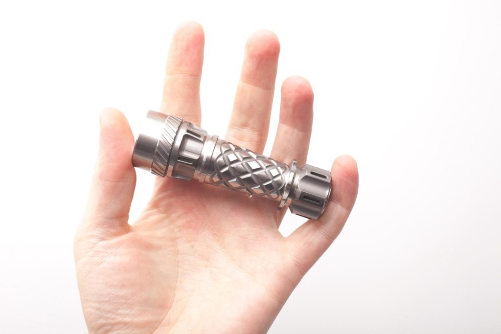 titanium jetbeam flashlight holding in hand