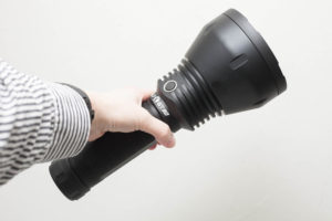 Lumintop BLF GT90 flashlight holding in hand on its side