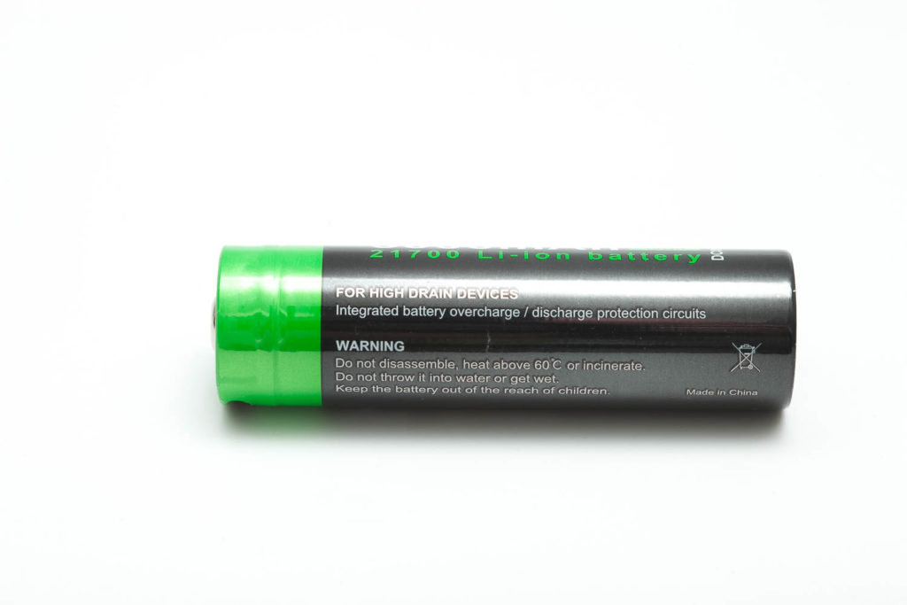 side view of black and green battery
