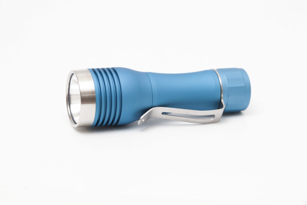 side view of a cyan colored flashlight