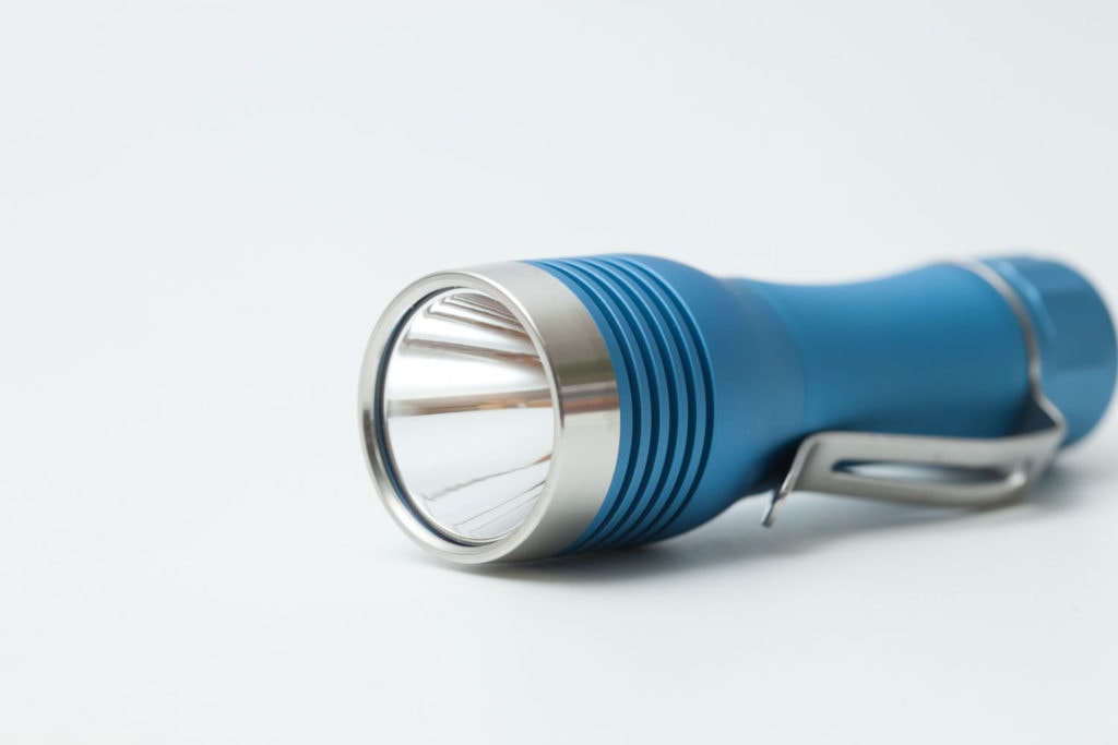 cyan flashlight with silver colored bezel